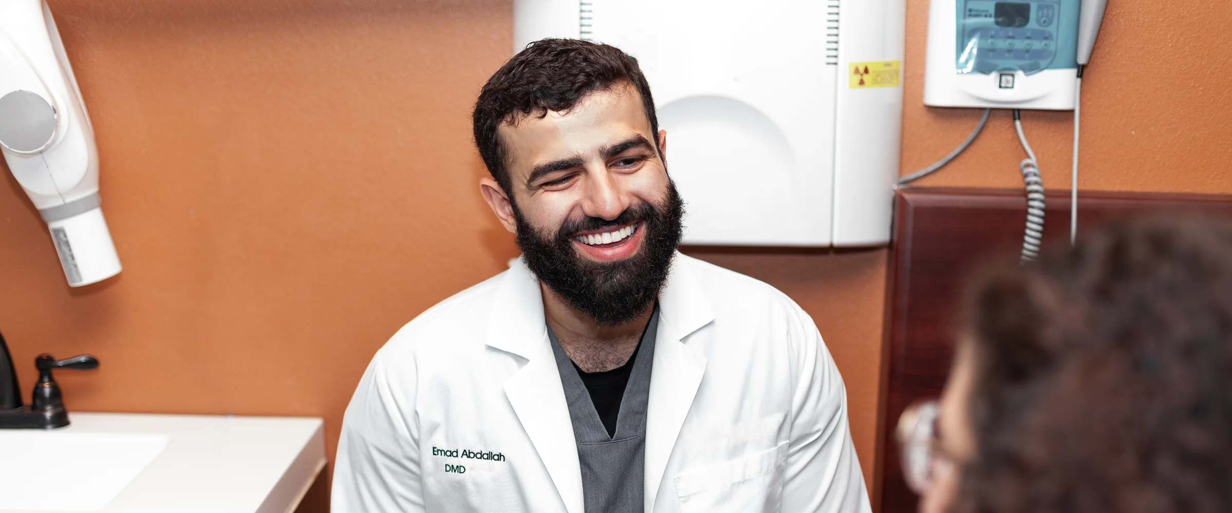 Dr. Emad Abdallah discussing treatment with a patient at Terrell Hills Dental in San Antonio