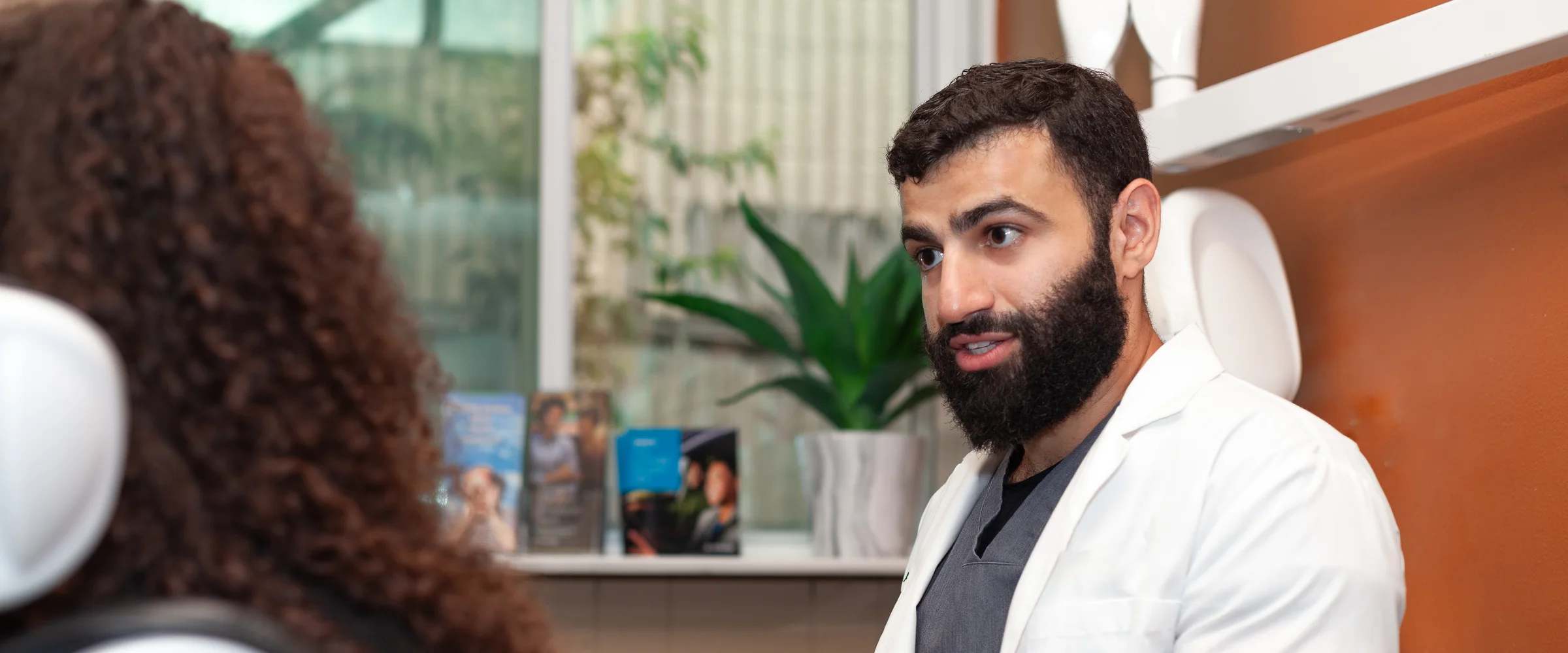 Dr. Emad Abdallah showing a treatment model to a patient at Terrell Hills Dental in San Antonio