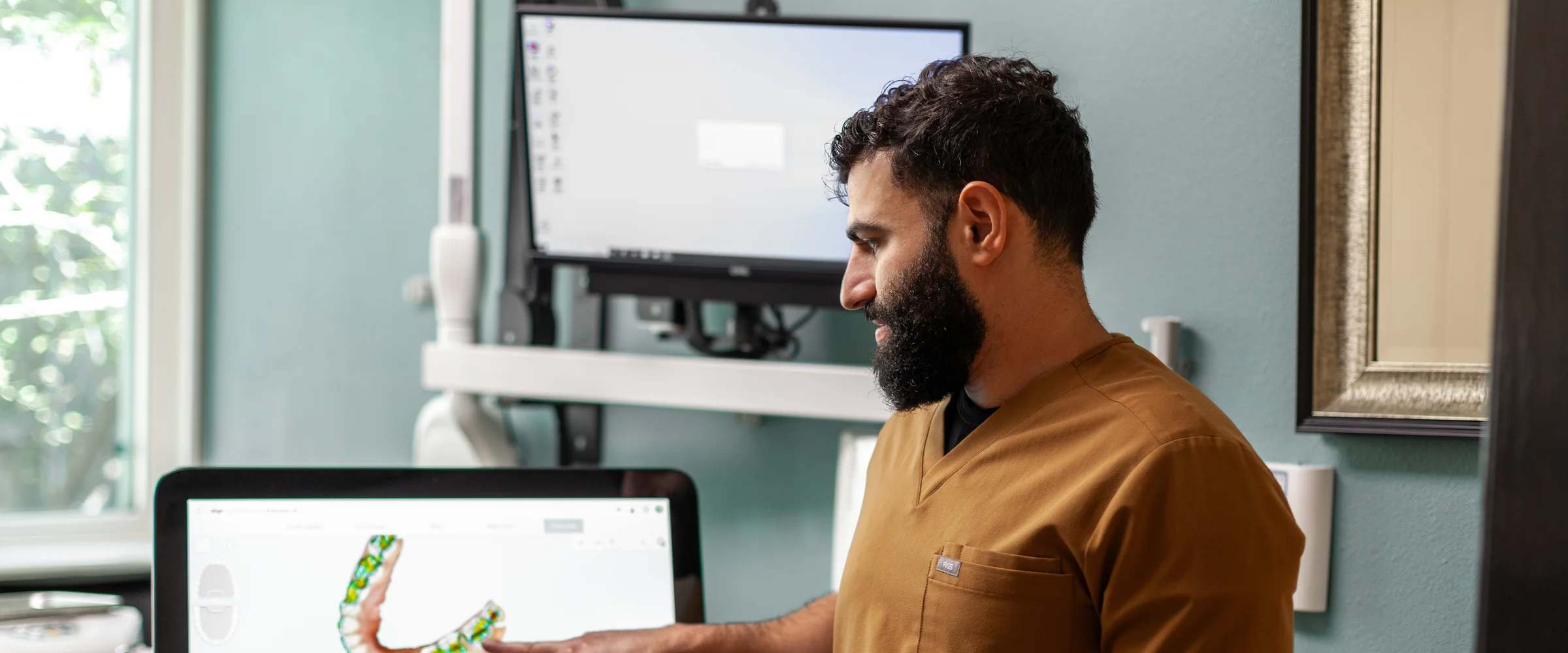Dr. Emad Abdallah reviewing a digital 3D scan on the iTero scanner at Terrell Hills Dental in San Antonio